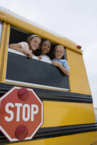 Young students looking out of school bus: RedLawList Accidents & Injuries Blog