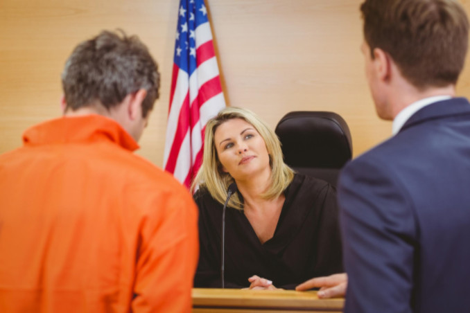 Defendant and lawyer with judge: RedLawList Accidents and Injuries Blog
