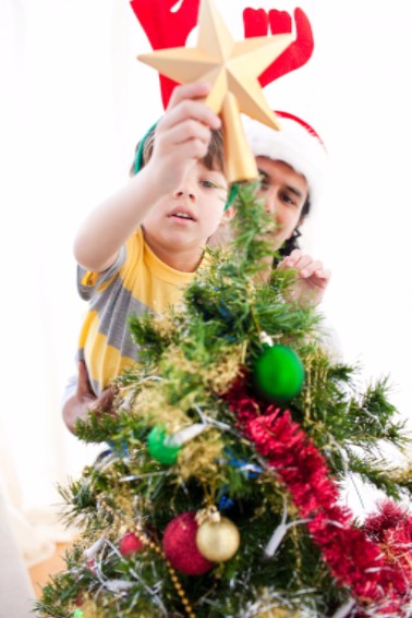 Father and son decorating Christmas tree: RedLawList Accidents & Injuries Blog
