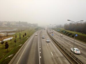 cars driving on highway in the fog