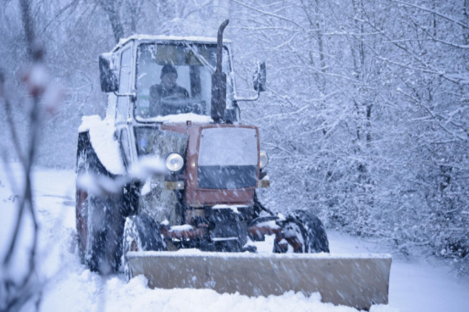 Man riding tractor in winter weather: RedLawList Accidents and Injuries Blog