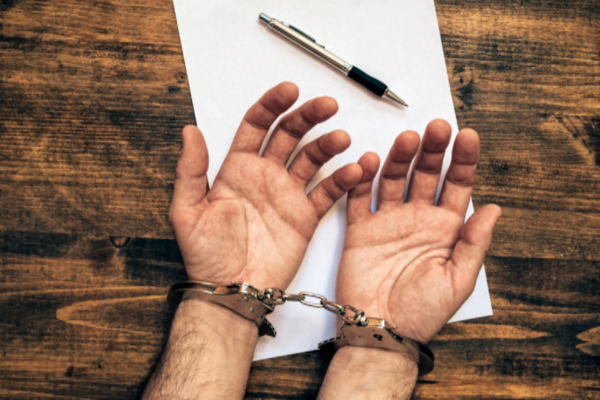 man handcuffed: RedLawList Criminal Law Blog