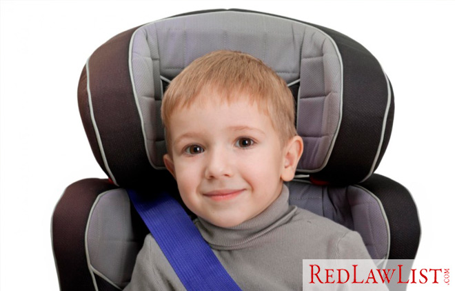 young boy sitting in car seat