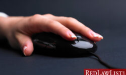 hand on computer mouse for an illegal online search